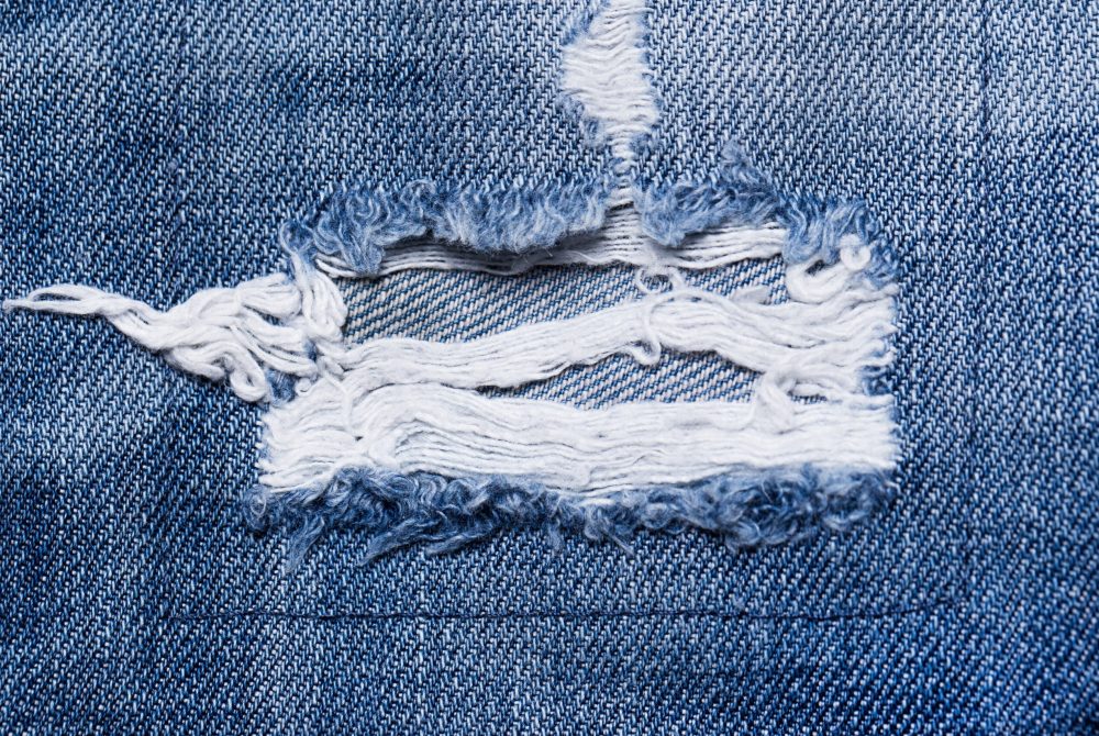 Closeup of a torn part of jeans A closeup picture of a part of the jeans that is a bit torn